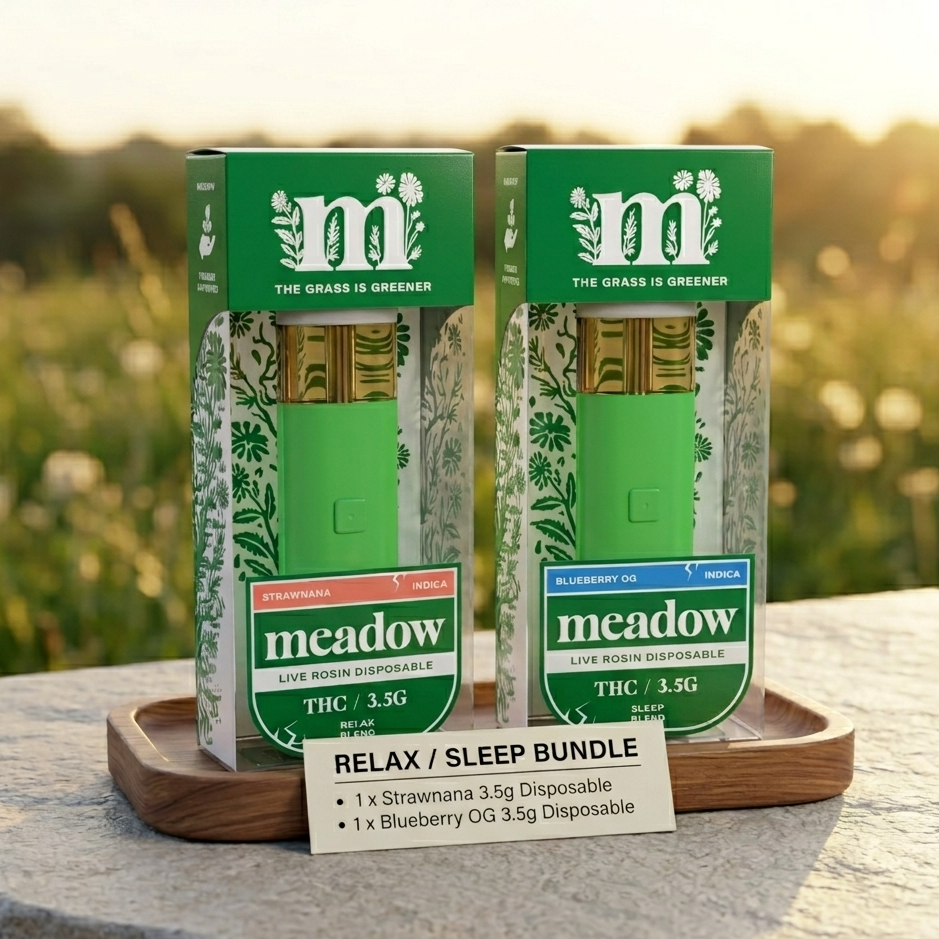 Two green boxes of 'm' brand products on a wooden tray with a blurred natural background.